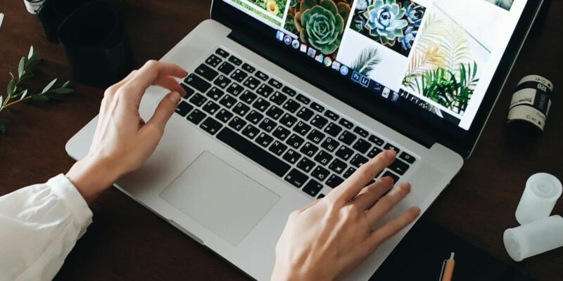 Person working on computer - IT cost analysis