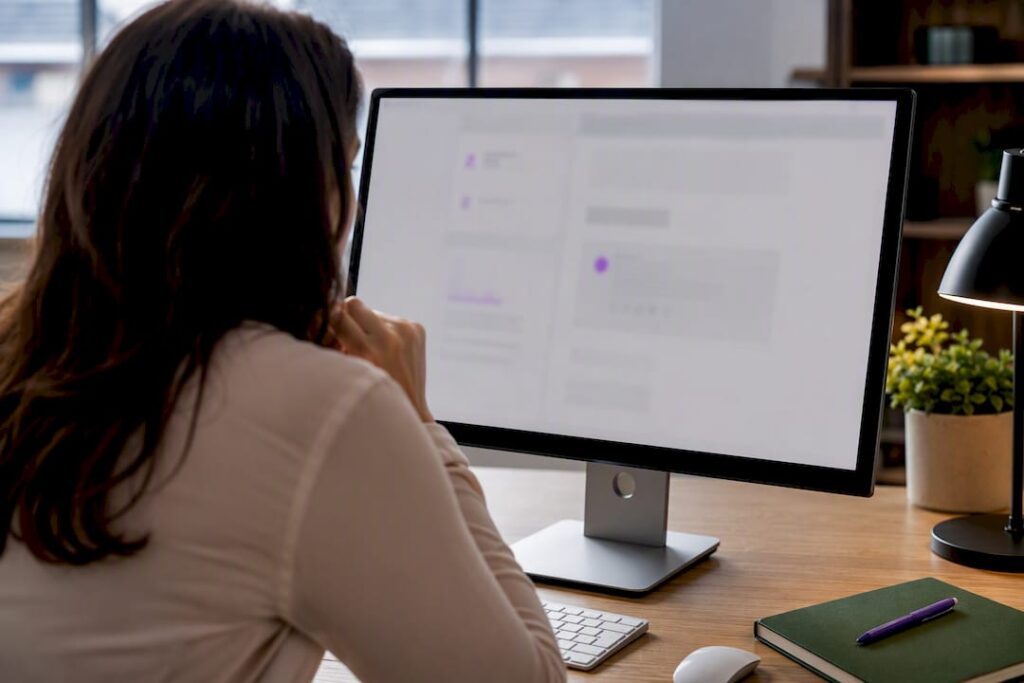 Person reviewing an email layout on a desktop monitor